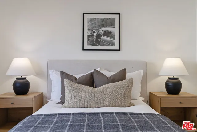 a bathroom with a granite countertop sink vanity mirror and toilet