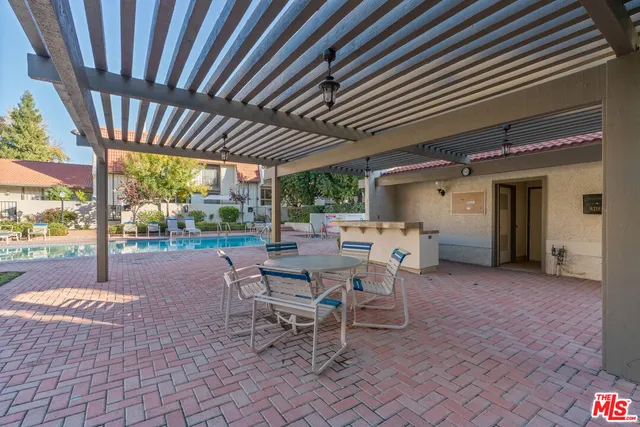 a view of a street with plants and large trees