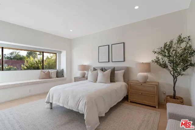 a bedroom with a large bed and a couch