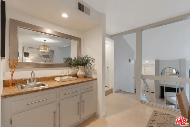 a spacious bathroom with a sink and a mirror