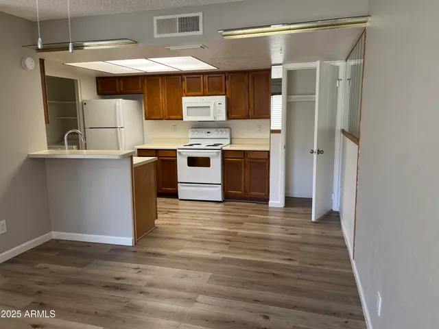 a kitchen with stainless steel appliances granite countertop a stove and a refrigerator