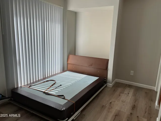 a bed sitting in a bedroom next to a window