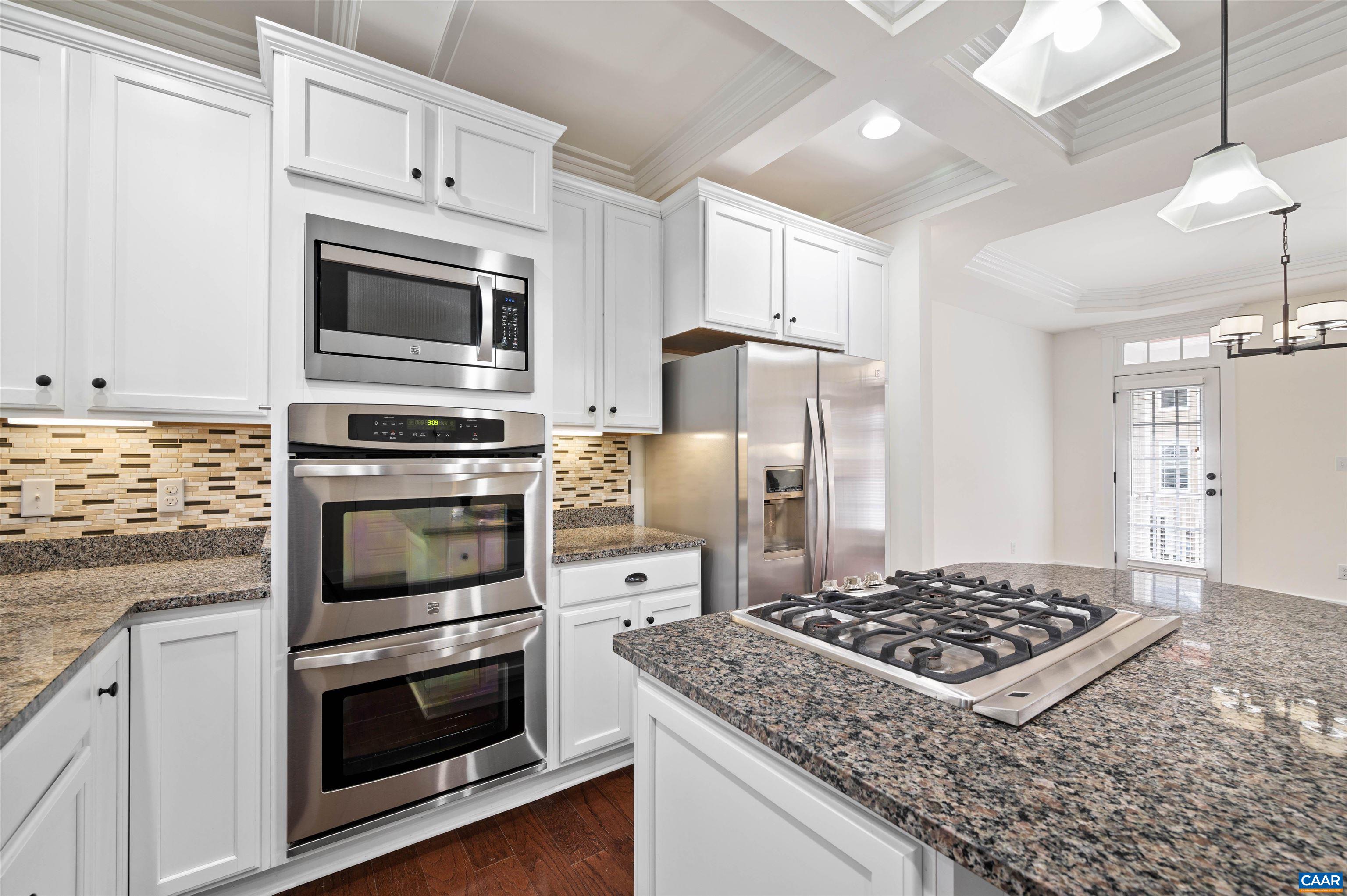 2054 Avinity Loop Charlottesville, VA 22902 - Photo 16 of 62 a kitchen with white cabinets and stainless steel appliances