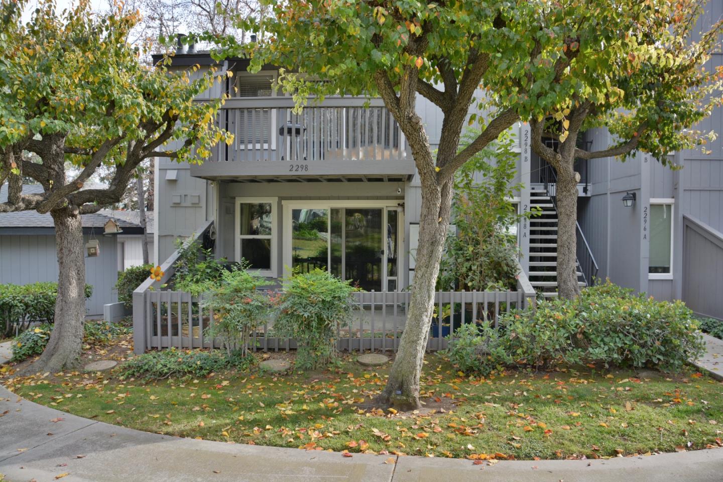 a front view of house with yard and trees around
