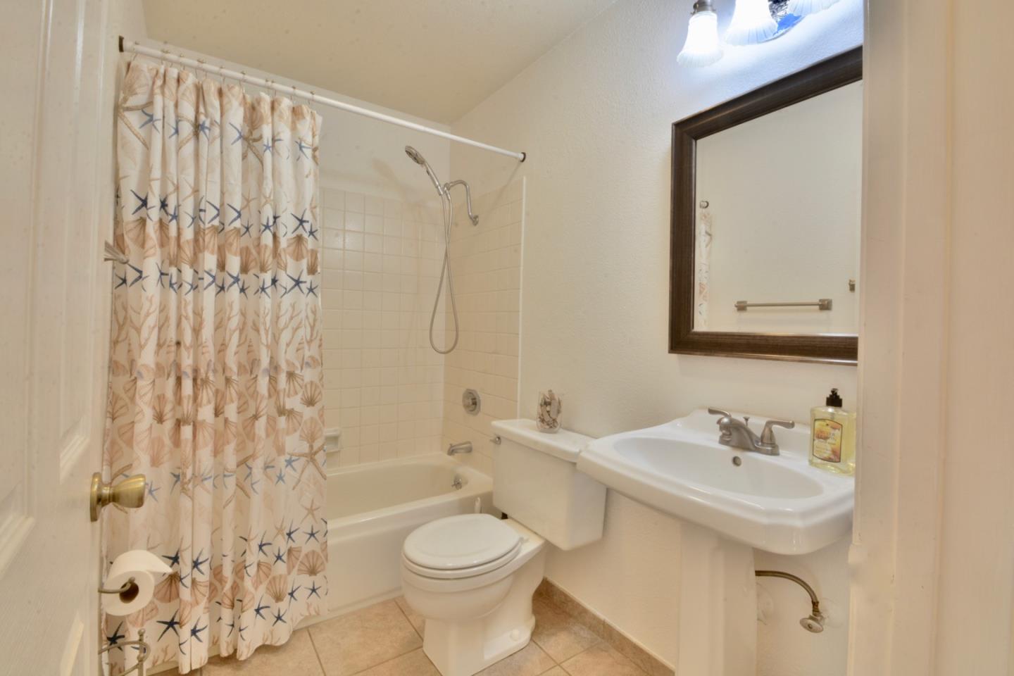2298 Almaden Road, Unit A San Jose, CA 95125 - Photo 32 of 43 a bathroom with a sink a toilet and shower curtain
