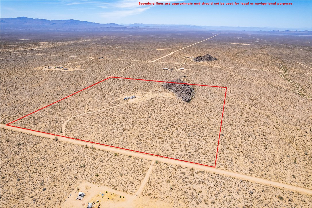 16435 South Wyatt Earp Road Yucca, AZ 86438 - Photo 48 of 57 Expansive desert lot featuring a large rock outcrop and distant mountains