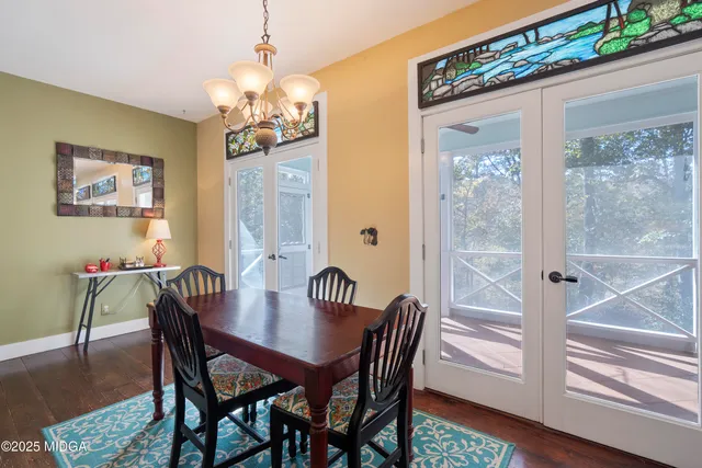 a view of a dining room with furniture wooden floor and a chandelier