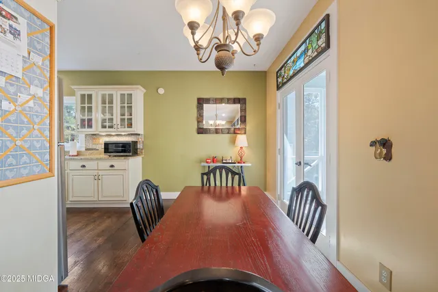 a view of a dining room with furniture and chandelier