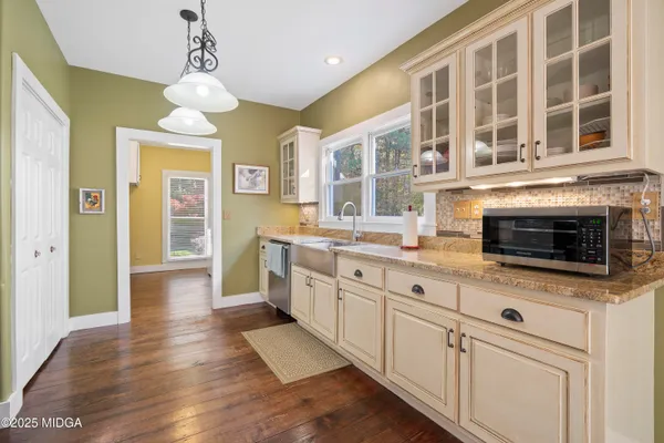 a kitchen with stainless steel appliances granite countertop a stove and cabinets