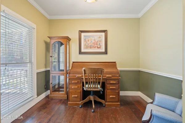 a view of a room with furniture wooden floor and front door