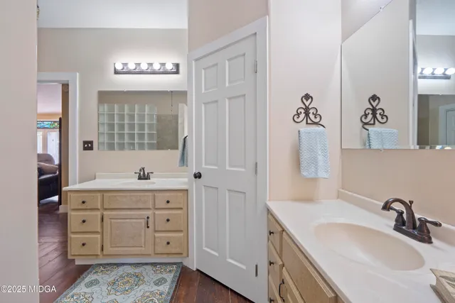 a bathroom with a granite countertop sink mirror and double