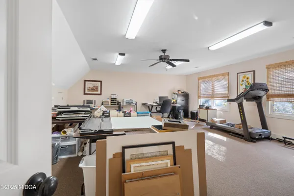 a room with gym equipment and a large window