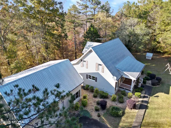 a view of a yard with large trees