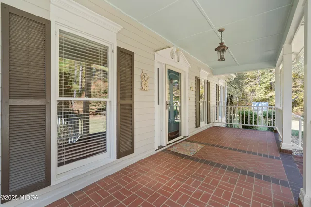 a view of a porch with wooden floor and iron stairs