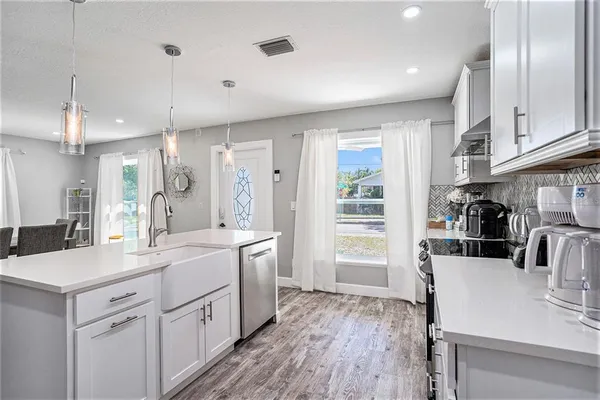 a bathroom with a sink vanity mirror and toilet