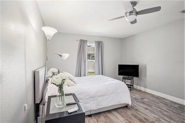 a bedroom with a bed and a chandelier