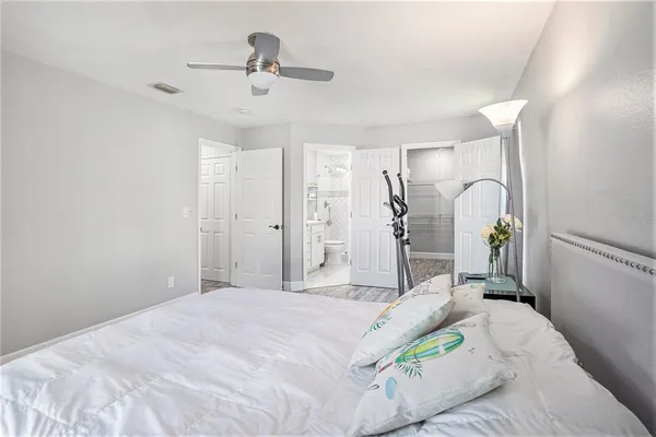 a bathroom with a double vanity sink toilet and a mirror