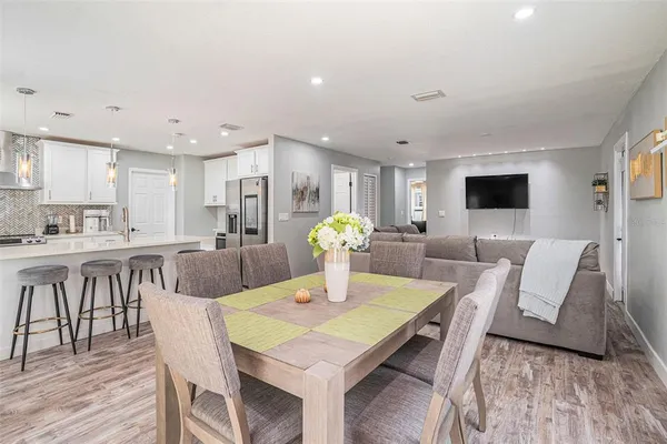 a view of a dining room with furniture and wooden floor