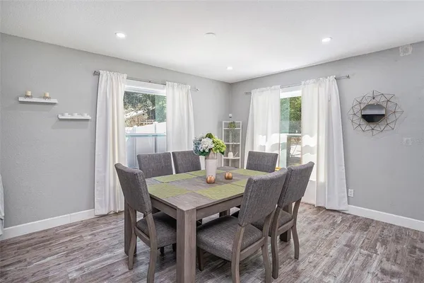 a view of a dining room with furniture window and wooden floor