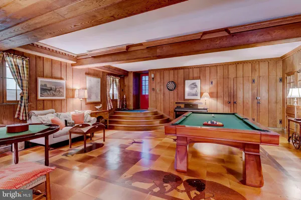 an aerial view of green landscape with trees houses and lake view