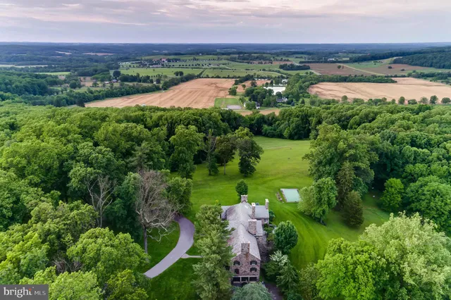a aerial view of a house with swimming pool and garden