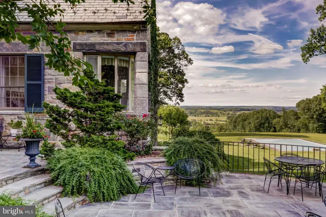 a view of a chairs and table in patio with a fire pit