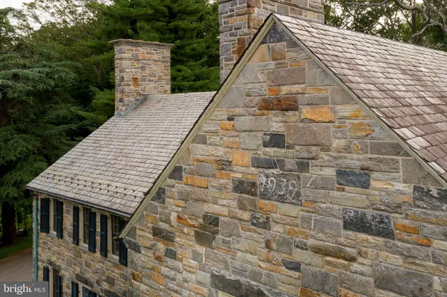 a room with lots of wooden furniture and large windows