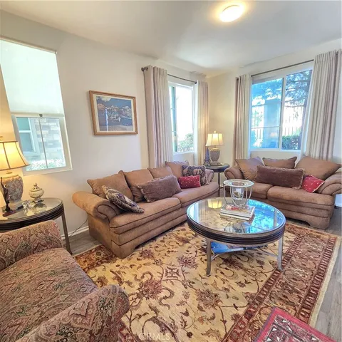 a living room with furniture a window and a lamp