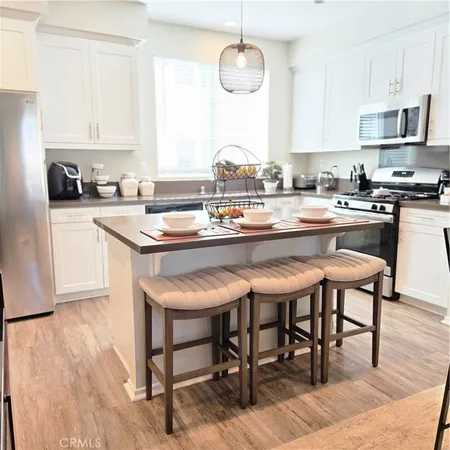 a kitchen with a dining table chairs and microwave
