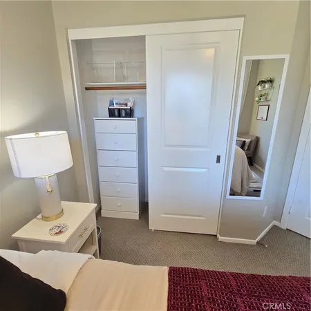 a bedroom with a bed and a walk in closet