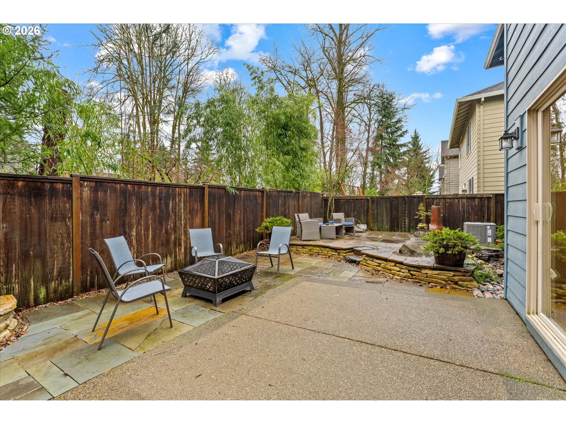 15680 Southwest 81st Avenue Tigard, OR 97224 - Photo 29 of 33 a backyard of a house with table and chairs