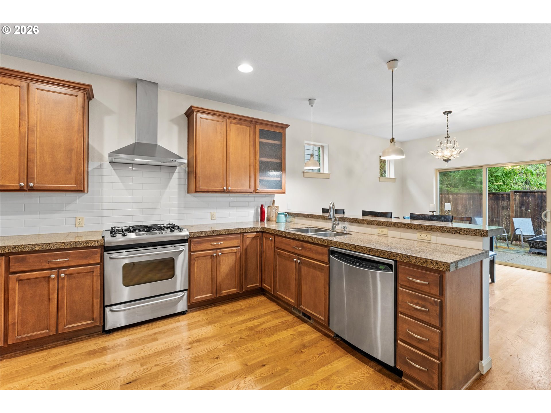 15680 Southwest 81st Avenue Tigard, OR 97224 - Photo 9 of 33 a kitchen with stainless steel appliances granite countertop a stove a sink and a microwave