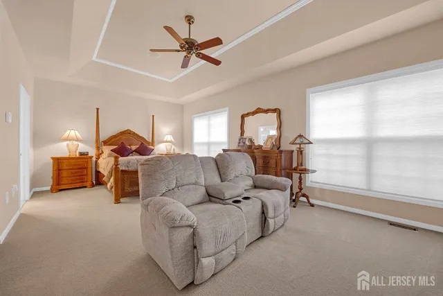 a bathroom with a granite countertop sink a mirror and shower