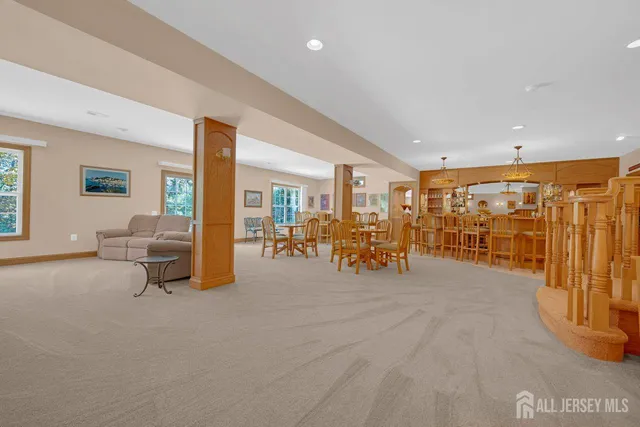a living room with lots of furniture and painting on the wall