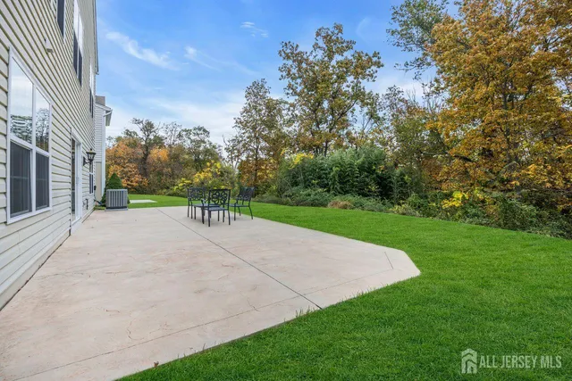a front view of a house with a yard and outdoor seating