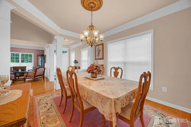 a view of a dining room with furniture and chandelier