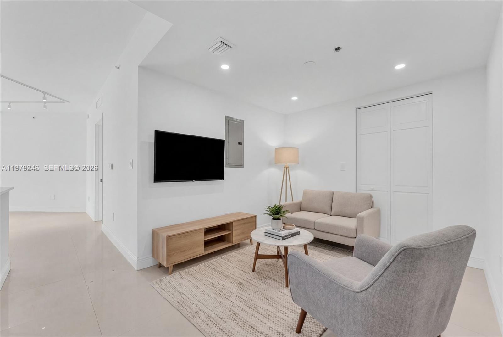 350 South Miami Avenue, Unit 2006 Miami, FL 33130 - Photo 17 of 33 a living room with furniture and a flat screen tv