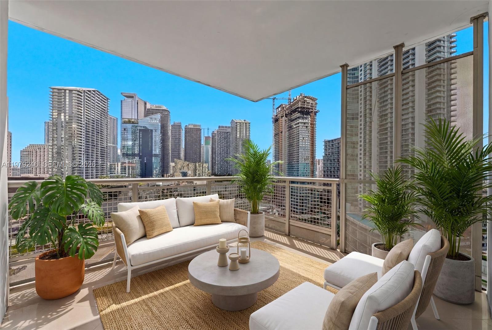350 South Miami Avenue, Unit 2006 Miami, FL 33130 - Photo 20 of 33 a view of a balcony with chairs and a potted plant