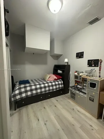 a bedroom with bed and a fireplace