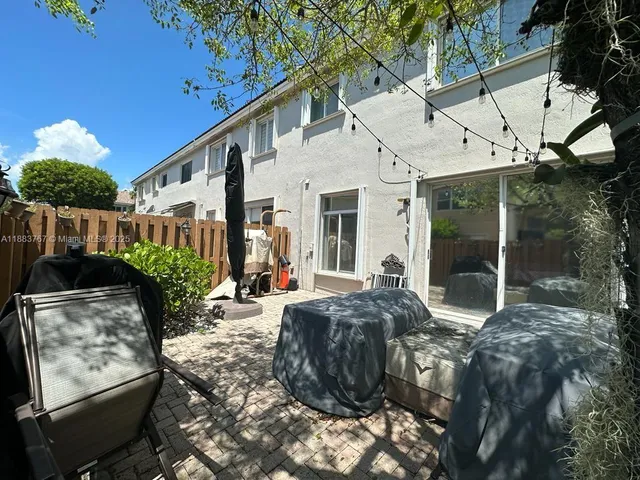 a view of a house with backyard and sitting area