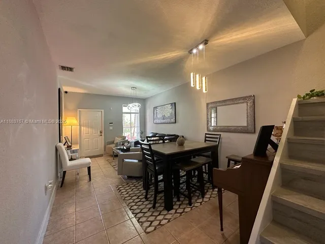 a view of a very nice looking dining room with furniture window and wooden floor