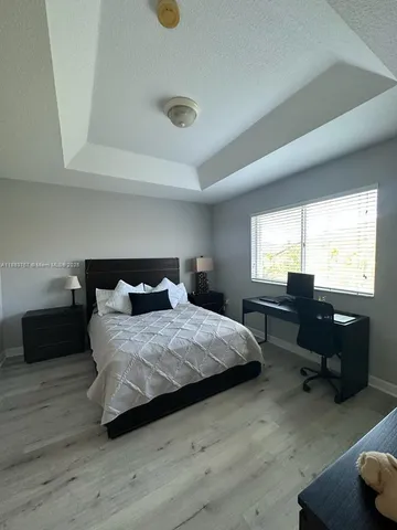 a bedroom with bed and window