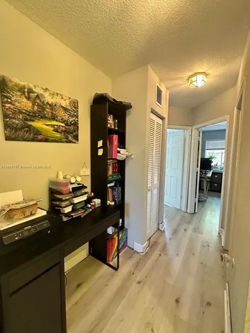 a kitchen with stainless steel appliances kitchen island granite countertop a refrigerator and a stove top oven