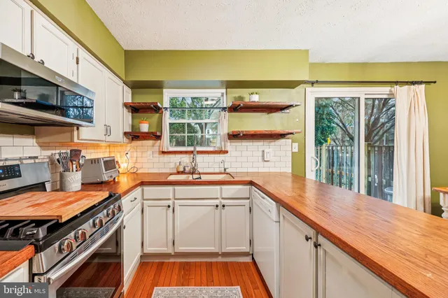a kitchen with stainless steel appliances a sink and a stove