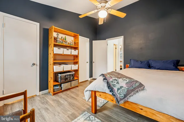 a bedroom with a bed and wooden floor