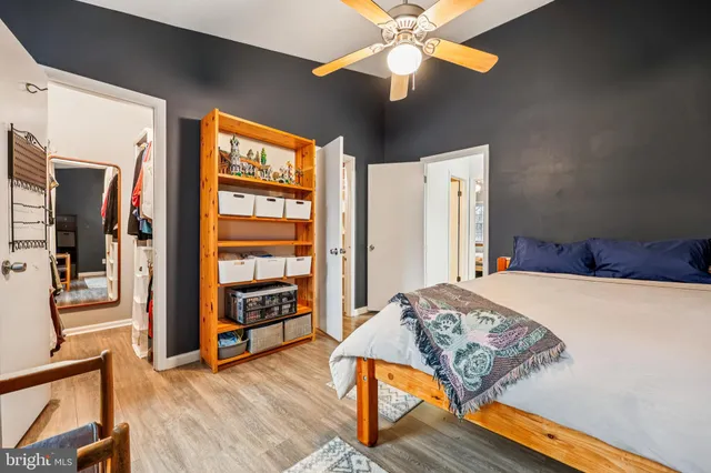 a bedroom with a bed and wooden floor