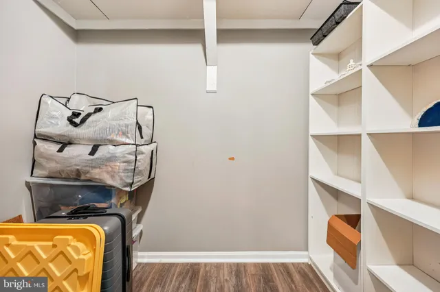 a view of walk in closet with clothes and shoes