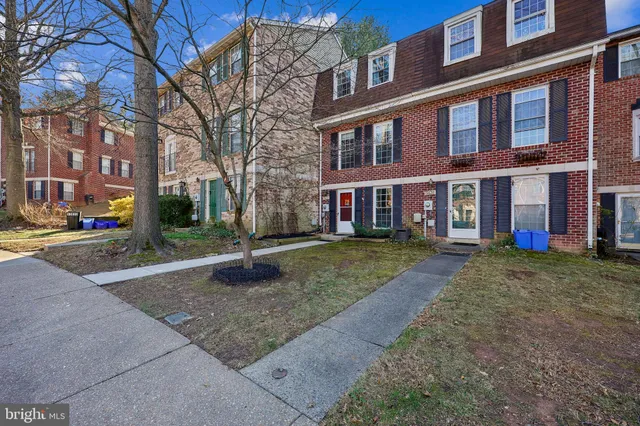 a living room with furniture a rug and a large window