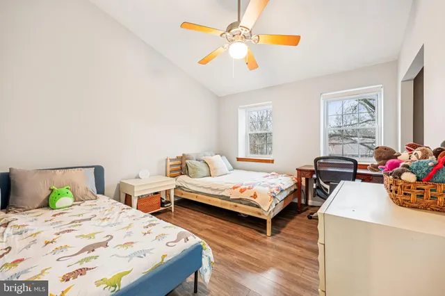 a bedroom with two beds and a chandelier