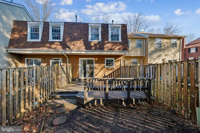 a view of a house with barbeque on wooden floor